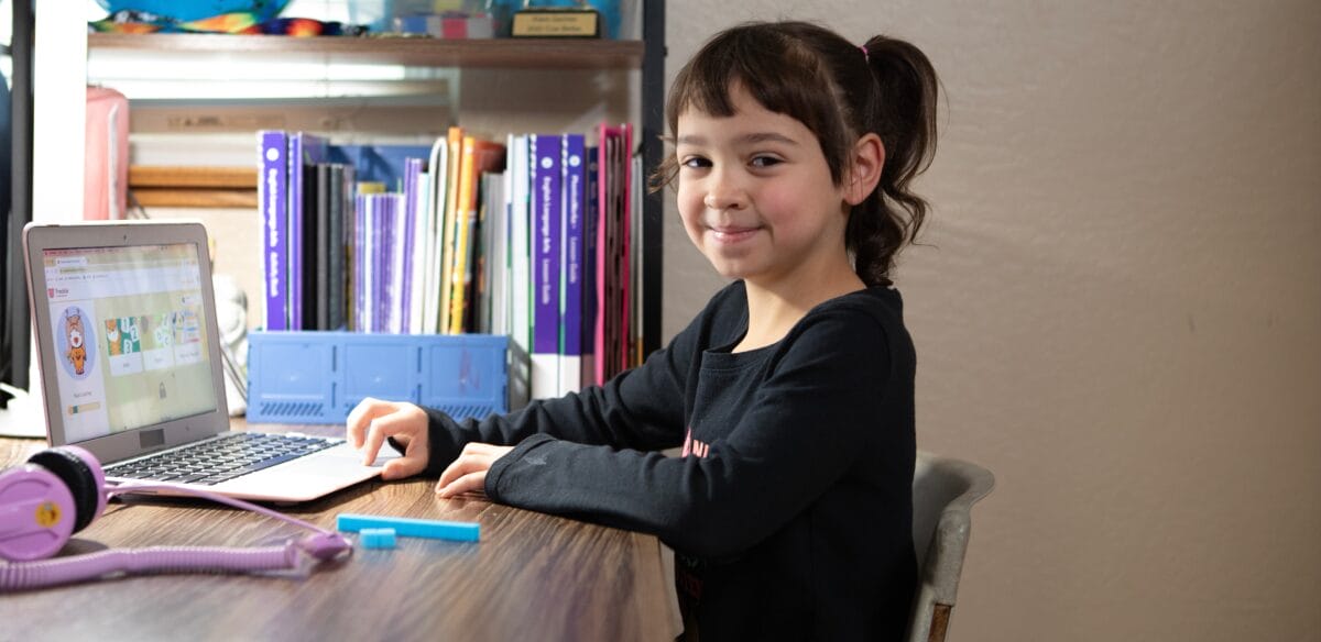 Elementary student attending to an online class at home