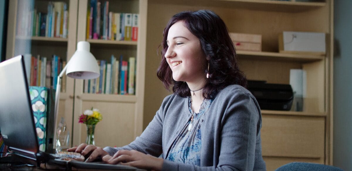 High school student attending to an online class at home