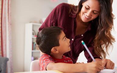 Mother and son taking notes together