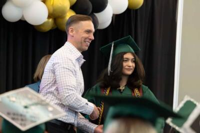 teacher with student at graduation