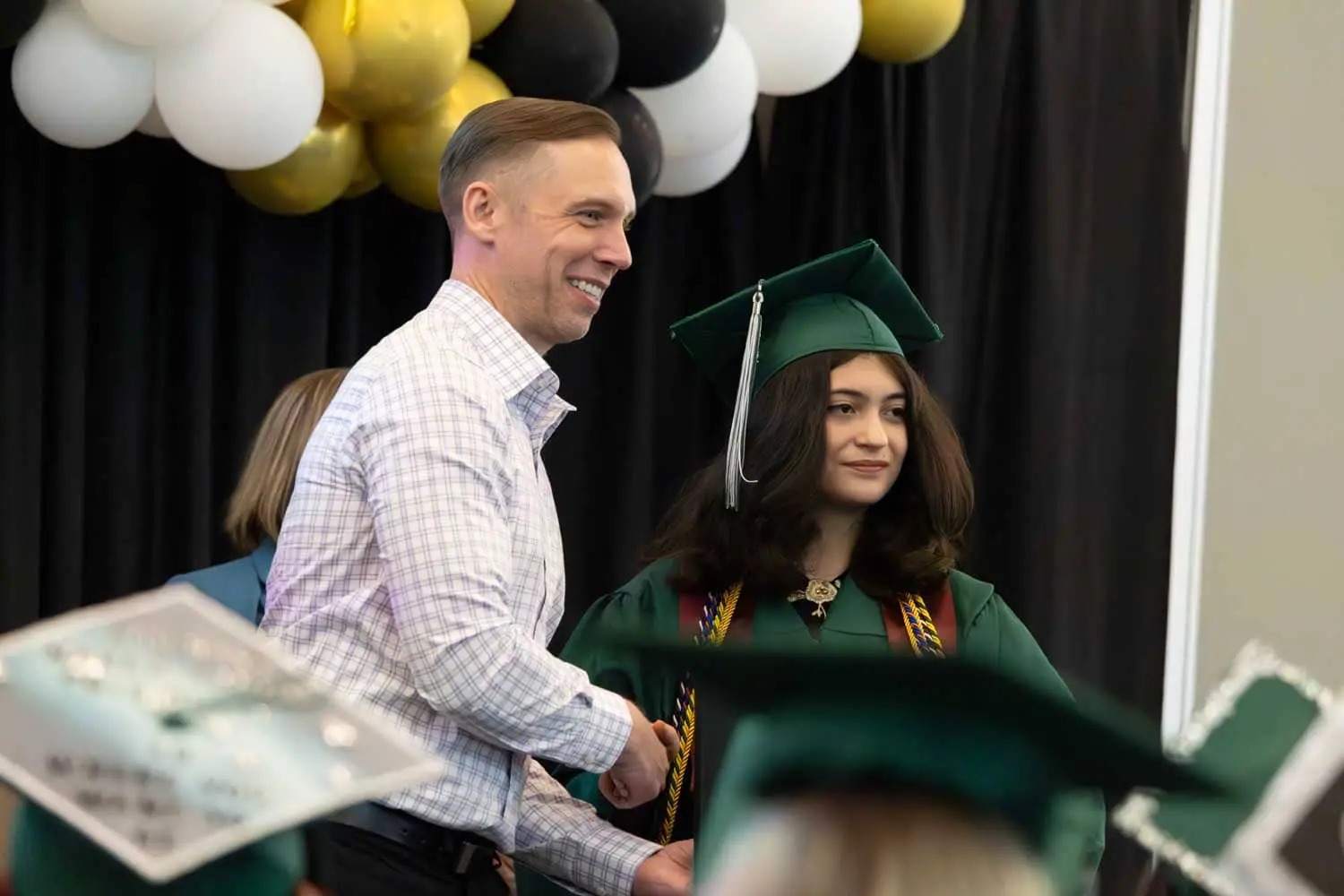 teacher with student at graduation