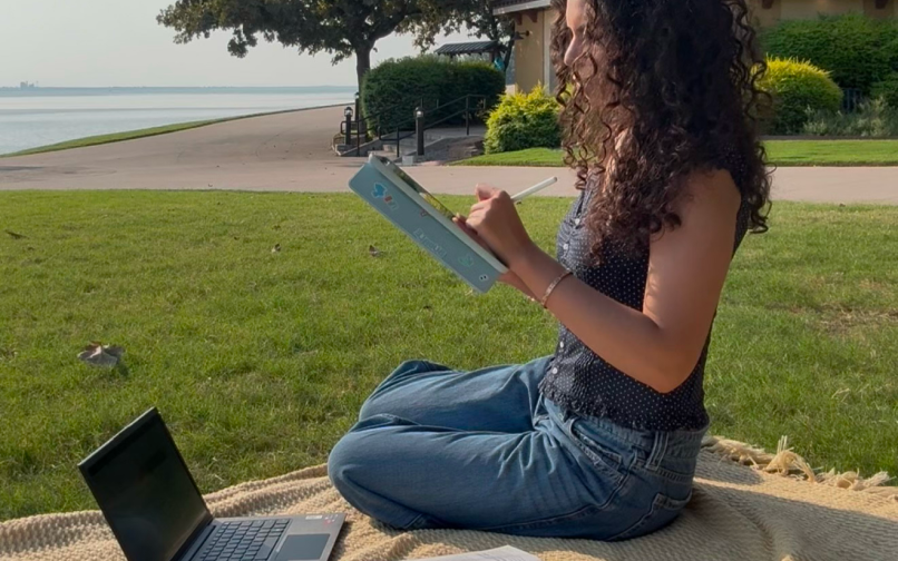 student reading at the park