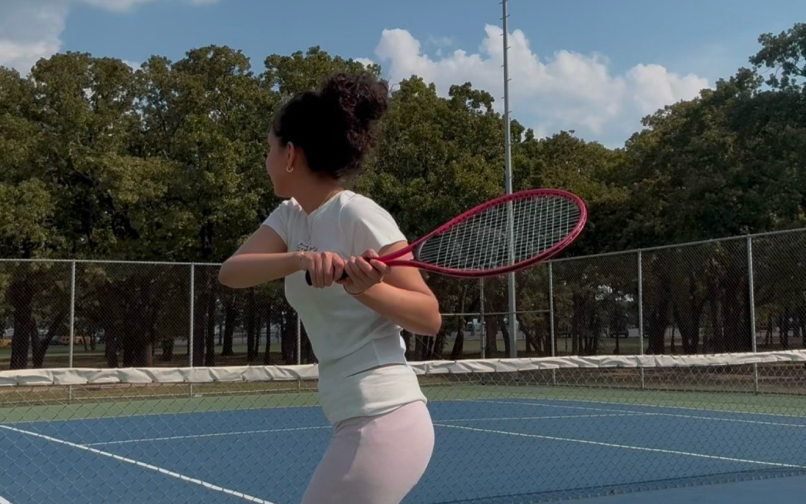 student playing tennis